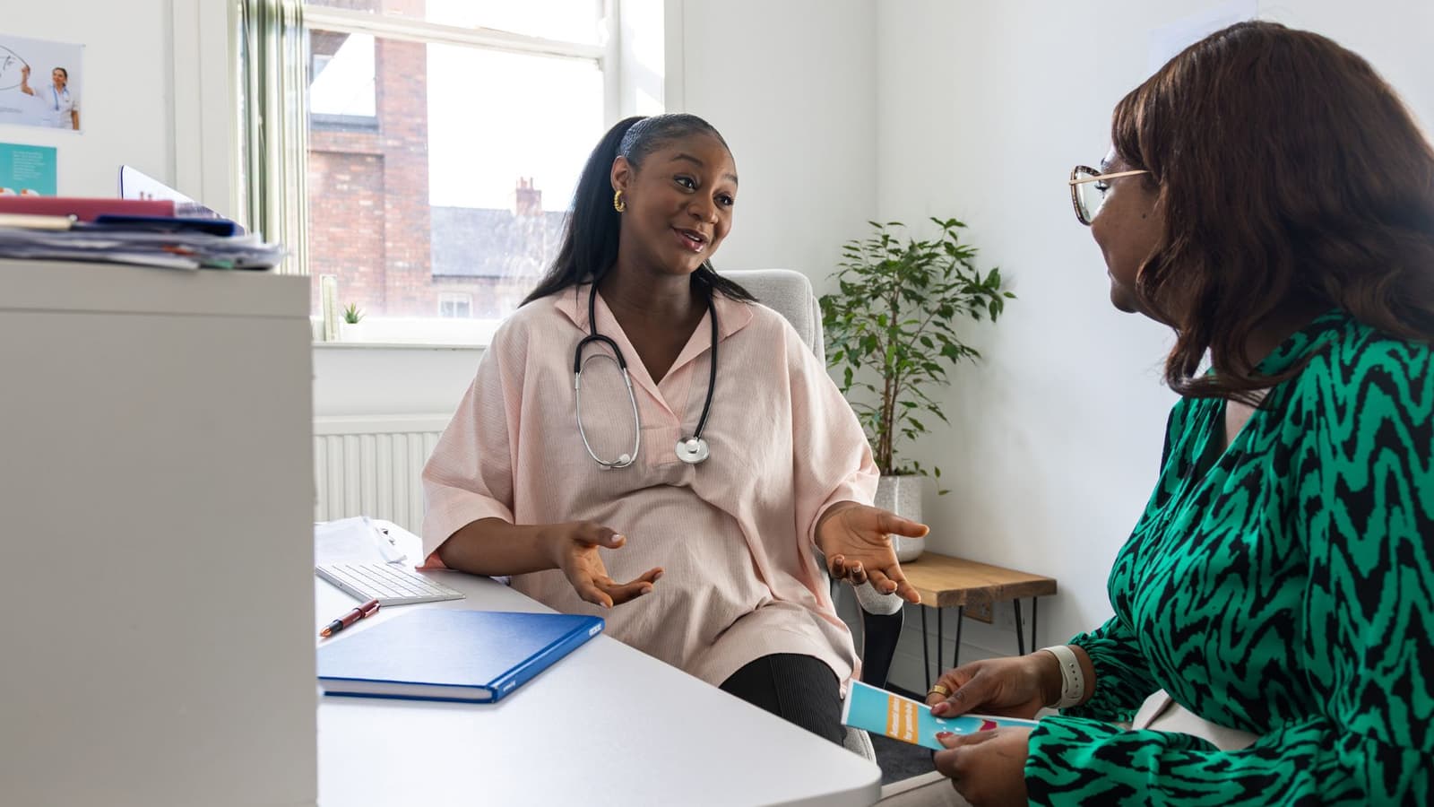 A healthcare professional talking through her situation with a mentor in a one-to-one meeting