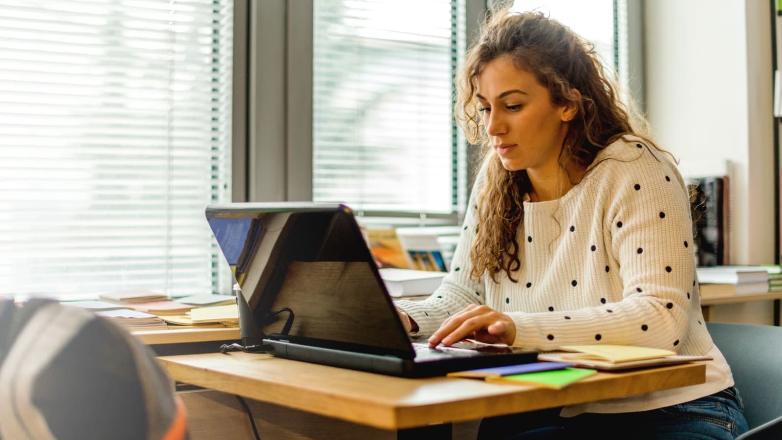 A person working quietly at a table at home