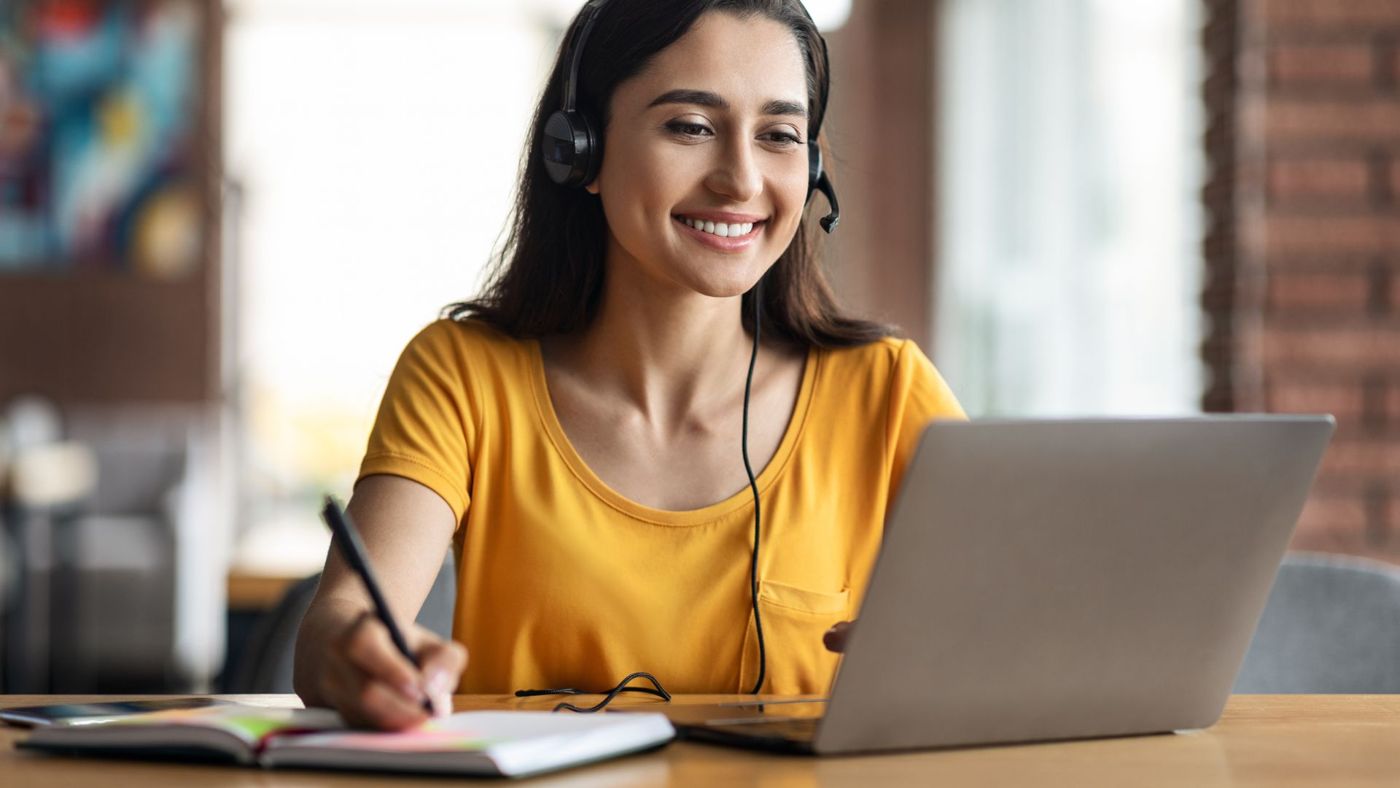 A nurse learning online at her laptop